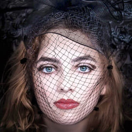 Close-up portrait of a woman wearing a dark veiled hat with red lipstick visible through the netting, demonstrating how to enhance shadow details in Photoshop