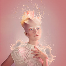 Surreal portrait of a person with pale skin composited with fiery liquid splashes around the shoulders and hair, illustrating how to cut out, blend, and color match a liquid portrait
