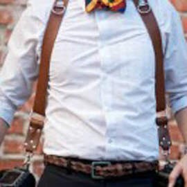 Close-up of a groom's outfit with suspenders and a patterned bow tie, illustrating wedding photography favorites