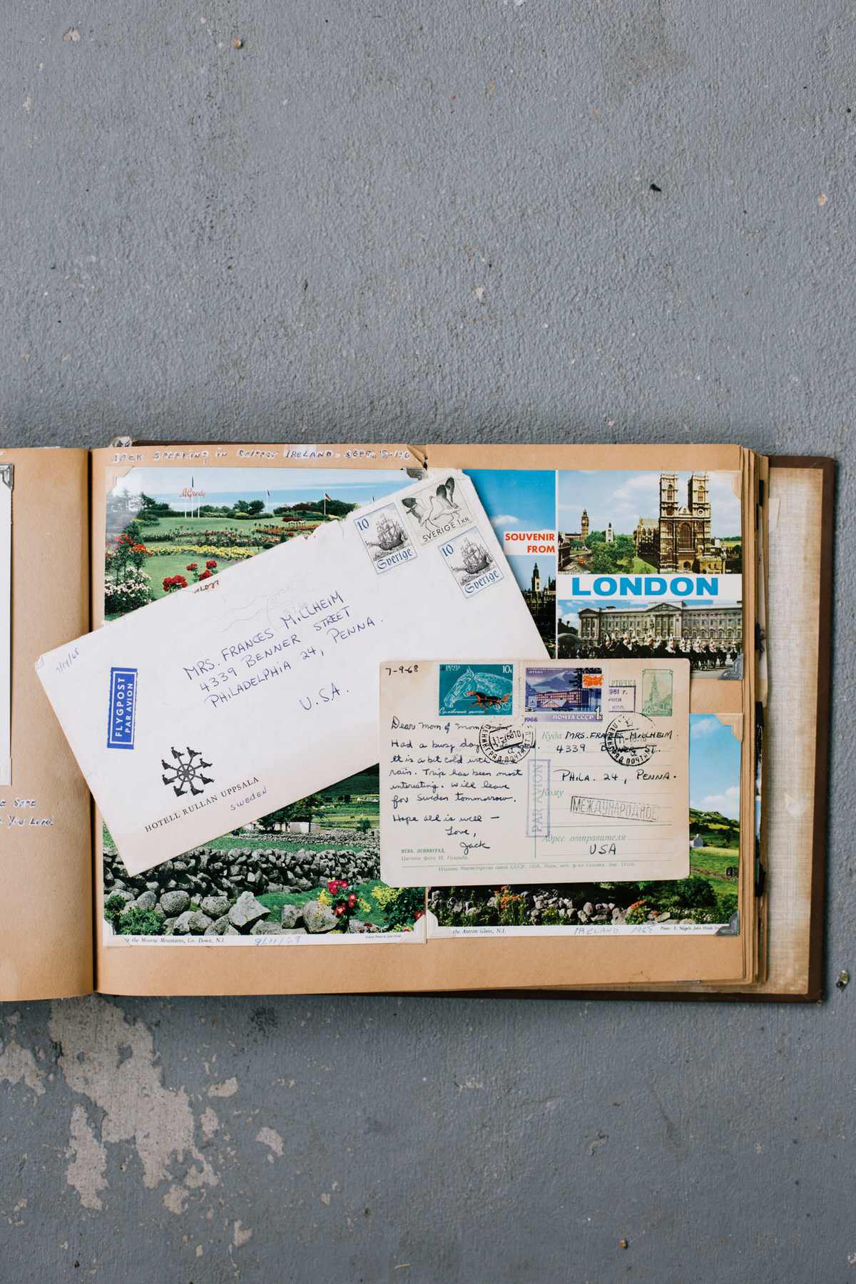Scrapbook page with a London souvenir postcard, other postcards and airmail letters addressed to Philadelphia