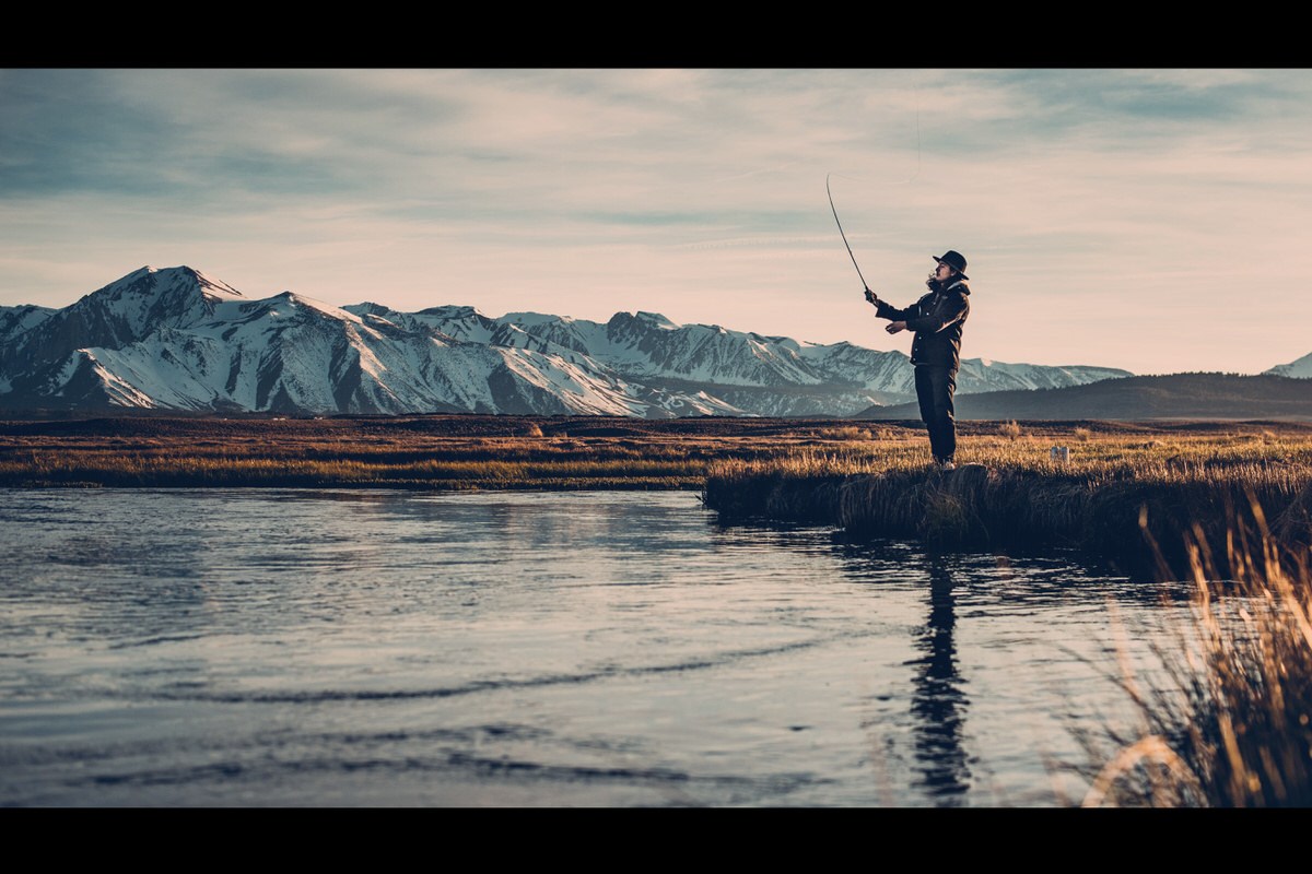 The finished fly fishing photo with cinematic blue-toned color grading and black letterbox bars applied