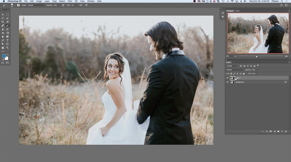 The original wedding photo of a bride and groom in a dry autumn field, with the background duplicated in the Layers panel