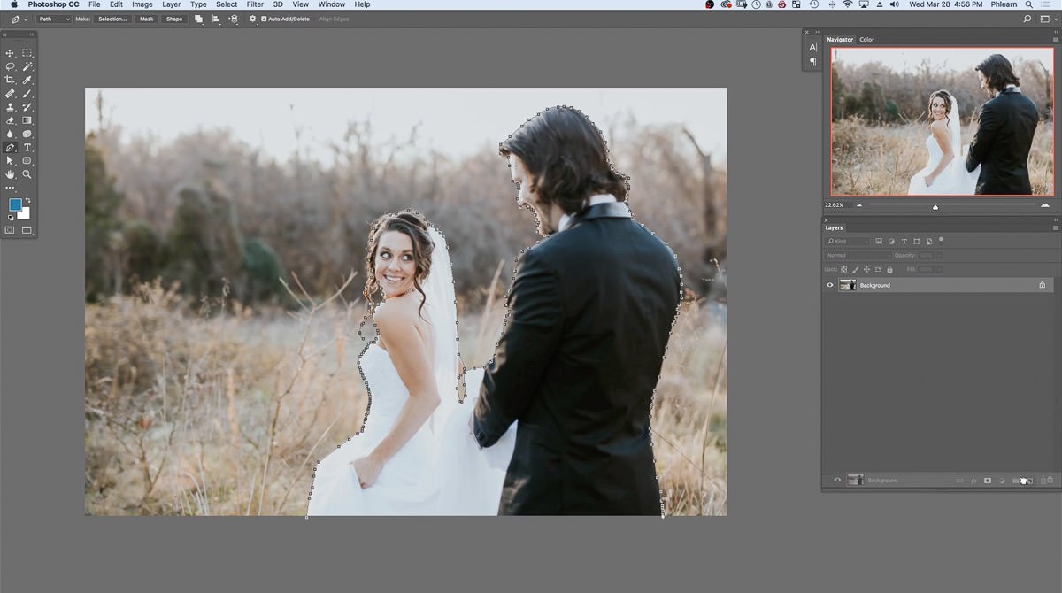 The finished Pen tool path around both the bride and groom, with the Background layer being duplicated in the Layers panel