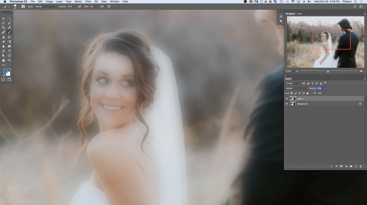 Zoomed in on the bride with the Gaussian-blurred layer at lowered opacity, spreading a hazy glow over the subjects
