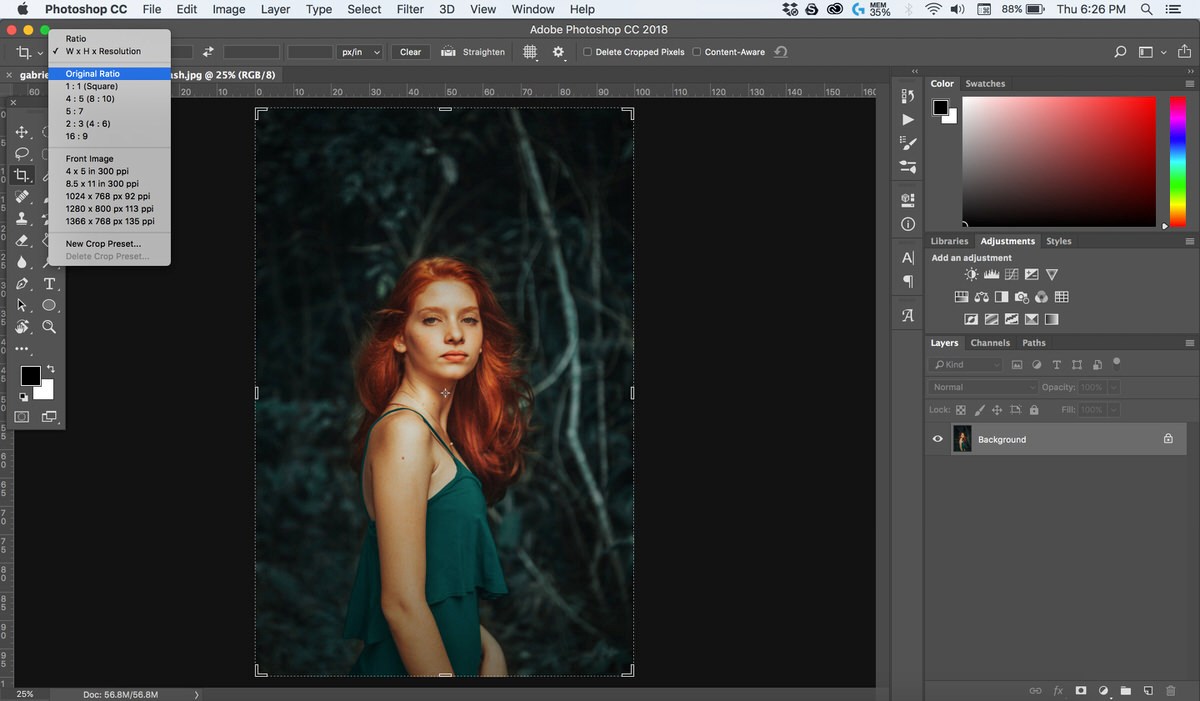 A studio portrait open in Photoshop with the Crop tool selected and the aspect ratio preset menu open