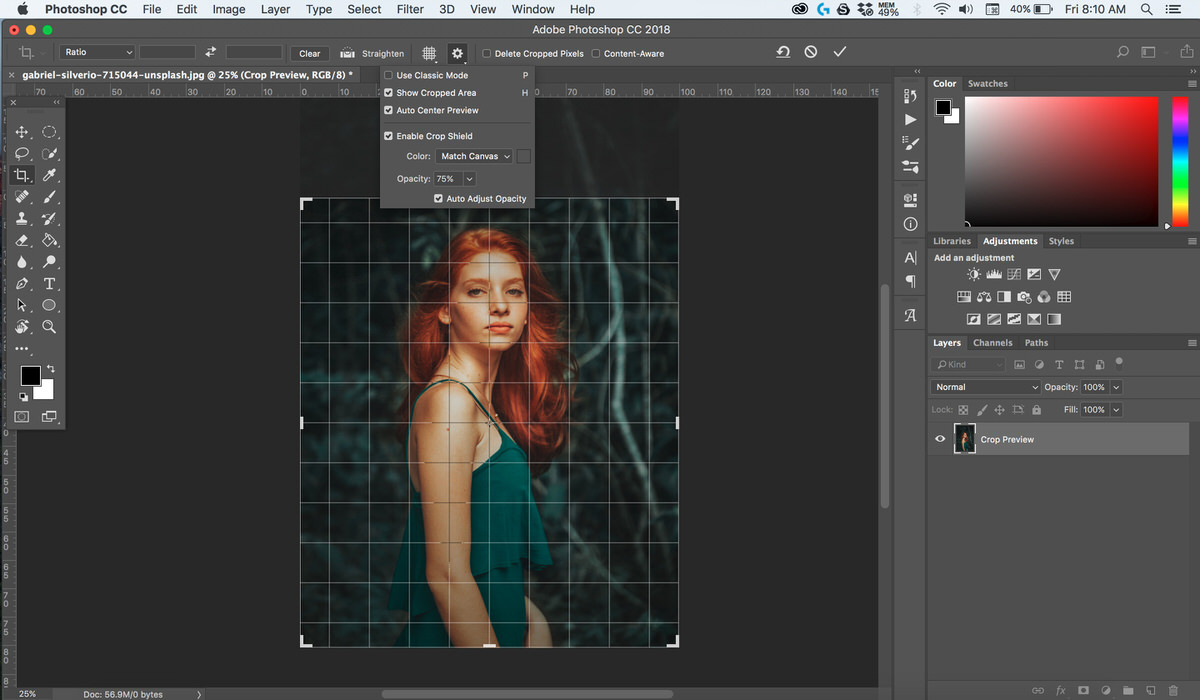 Photoshop screenshot showing the Crop tool active on a portrait photo, with crop guides overlaid
