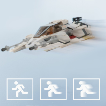 Blurred LEGO Star Wars snowspeeder toy in motion with running-figure motion icons below, example for understanding shutter speed with Star Wars LEGO