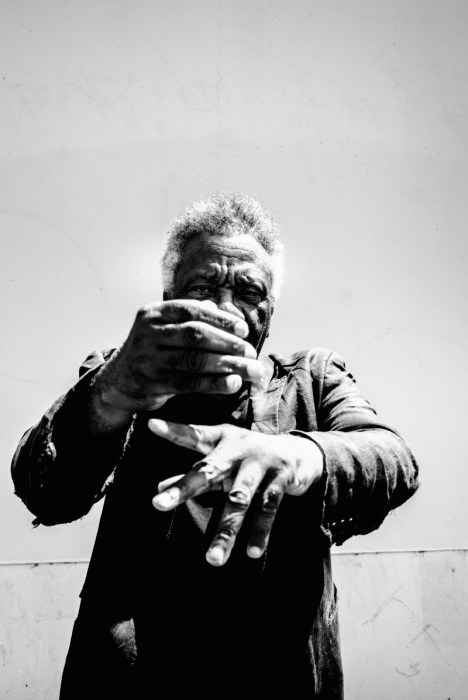 Black-and-white portrait of Donald Byrd with his hands crossed in front of his chest, partly covering his face