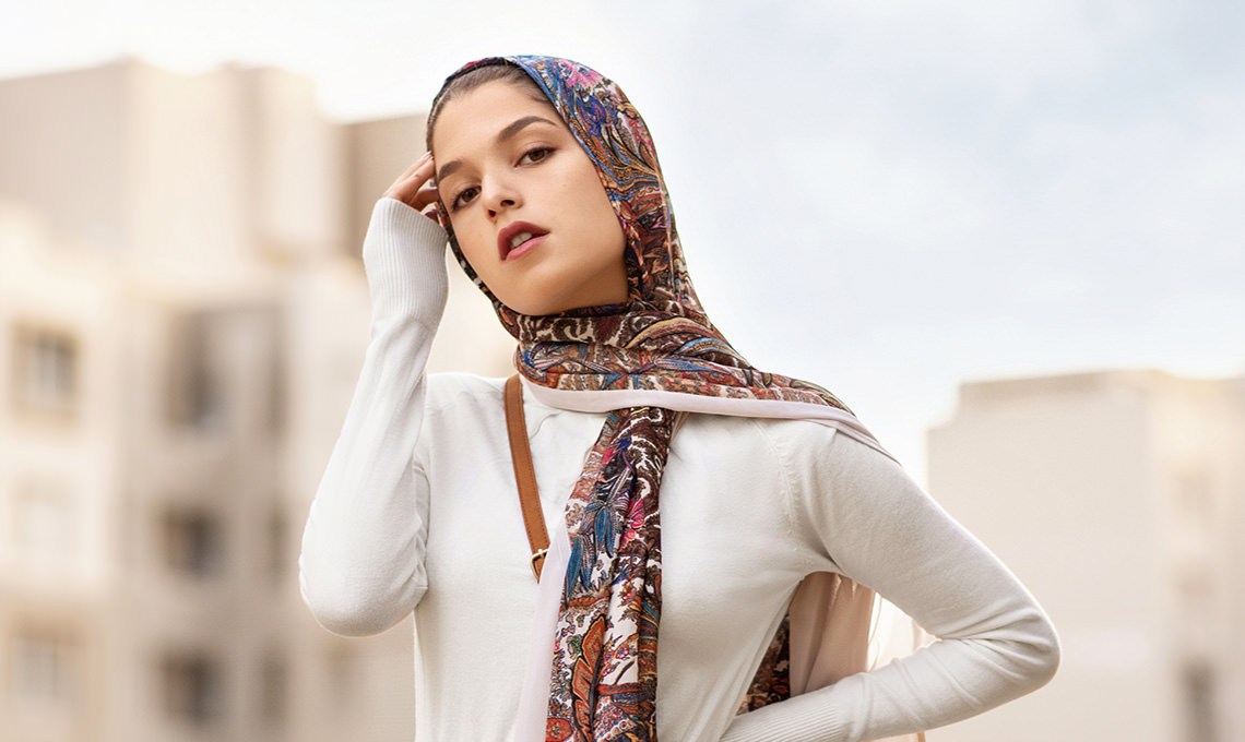 Woman in a patterned headscarf shielding her eyes from the sun, before the Sharpen action is applied