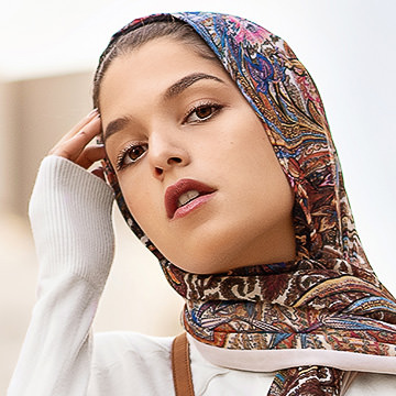 Close-up of a woman wearing a patterned scarf and cream sweater with sharp, crisp detail, example for the Smart Sharpen Photoshop Action