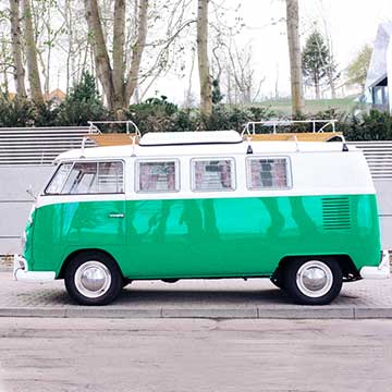Vintage green and white Volkswagen camper van parked on a tree-lined street, example for selecting and changing colors in Lightroom