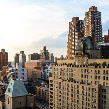 New York City rooftop view of historic and modern apartment buildings with converging vertical lines, example for straightening buildings with grids in Photoshop