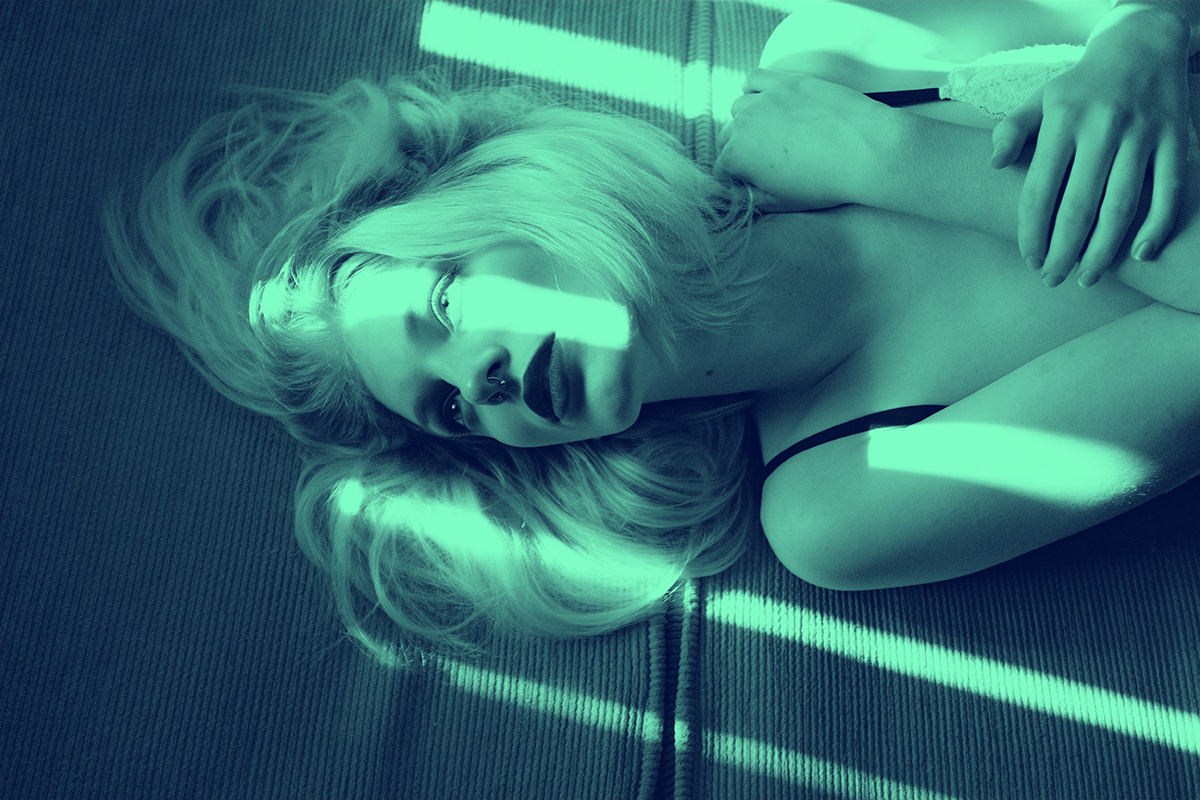 the same portrait after a teal and black duotone has been applied