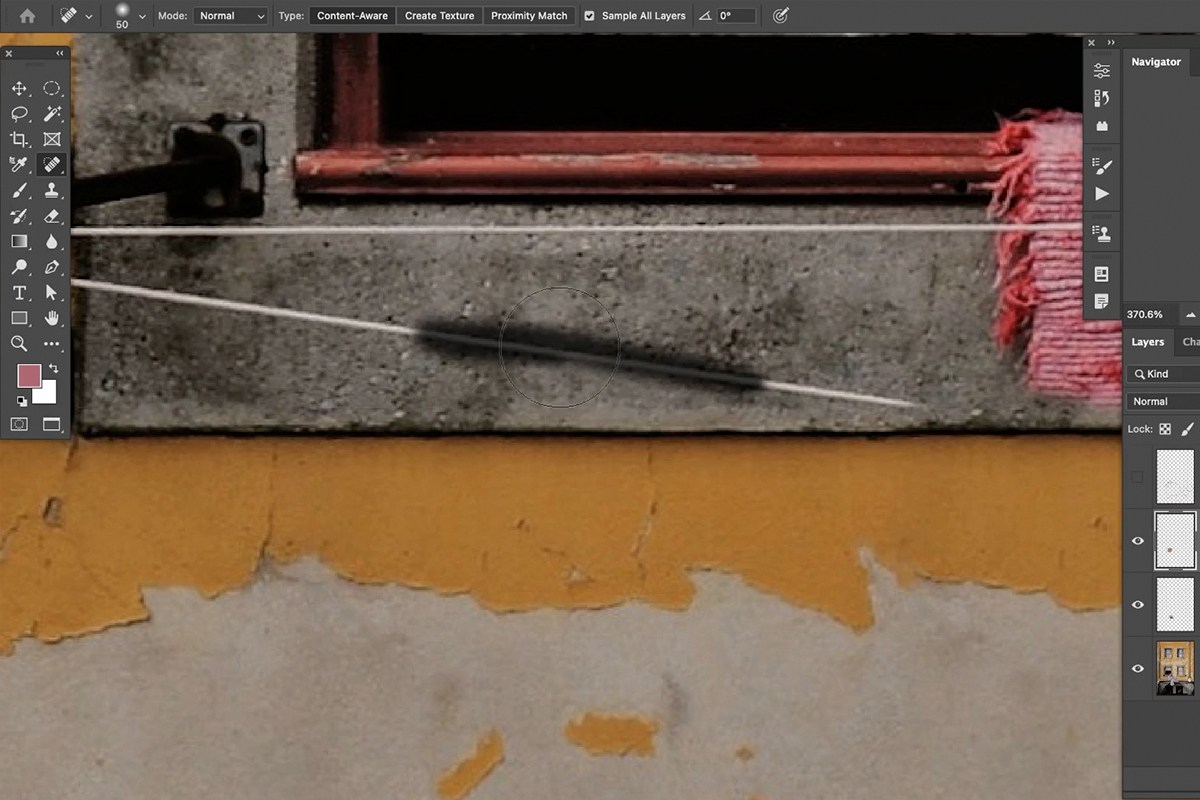 Spot Healing Brush painting over a simple line on a plain section of the background