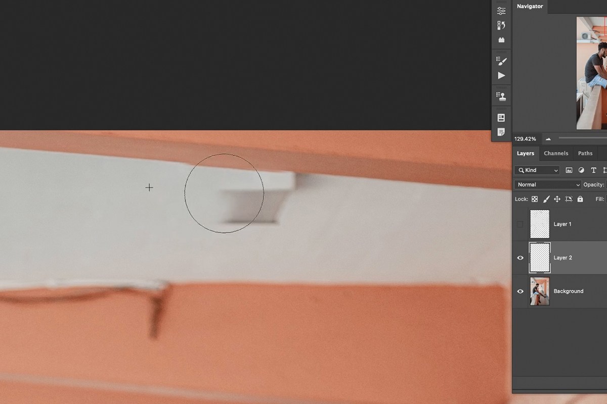 Brush tool sampling the wall color and overpainting a large flat area on a new layer