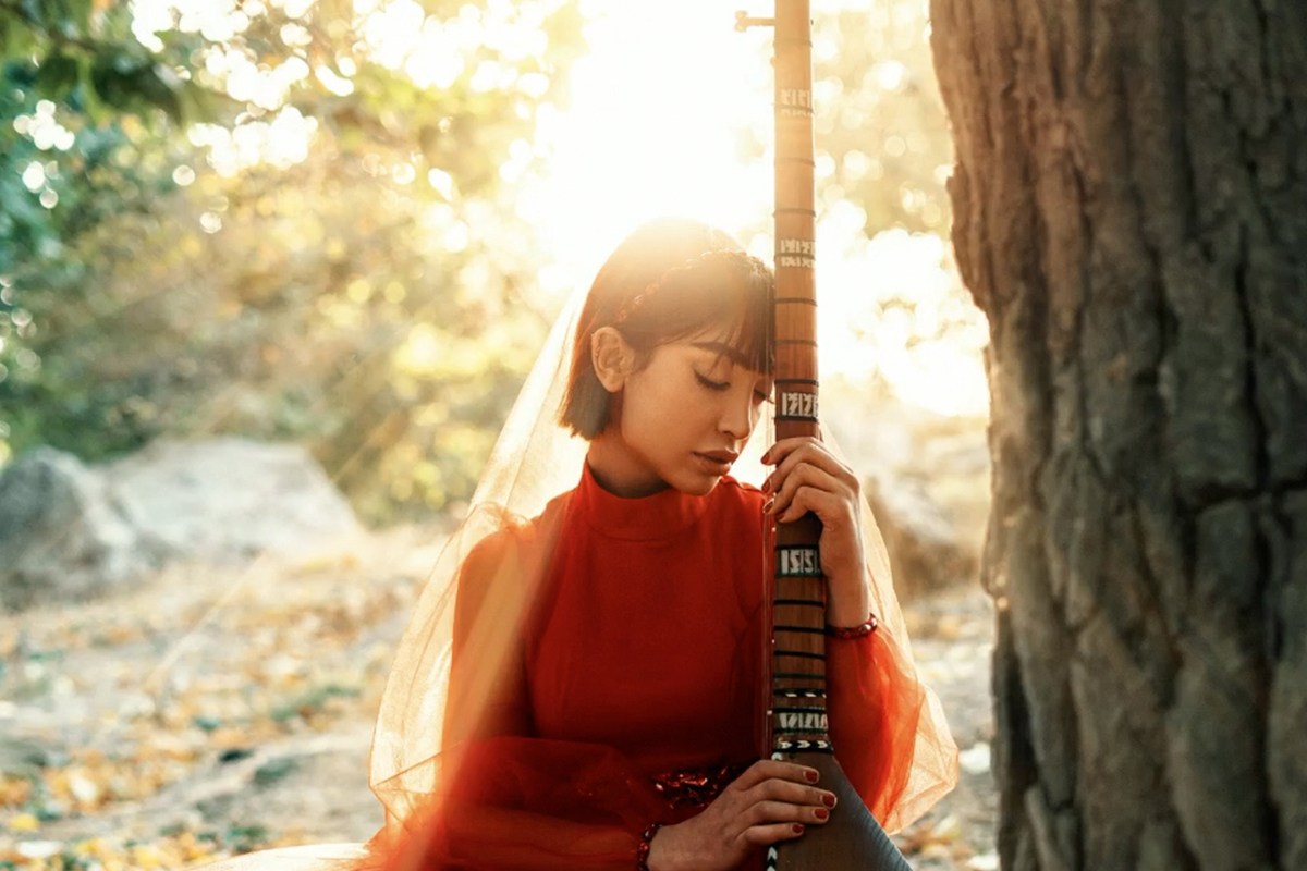 The finished photo with soft, warm light rays streaming through the trees behind the subject