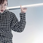 A woman in a checked top holding a bar