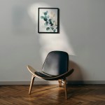 A chair beside a wall with a framed print