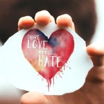 A hand holding a heart-shaped card