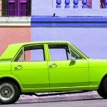 A lime green car in front of a purple building