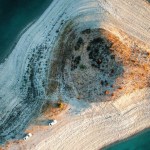 An aerial view of a turquoise coastline