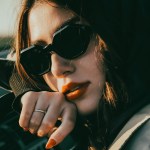 A woman in sunglasses in a car