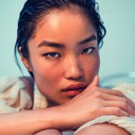 A woman with wet hair resting her chin on her hands