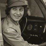 A vintage photo of a woman in a car