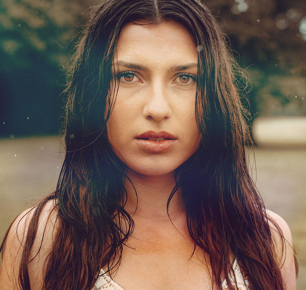The same portrait after light leaks, bokeh and borrowed color were added with blending modes in Photoshop