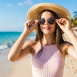 A woman in a sun hat on a beach