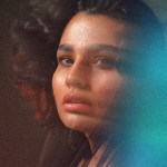A woman lit in blue and red