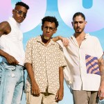Three men in summer shirts under a blue sky