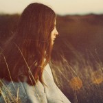 A woman in a field at golden hour