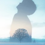 A double exposure of a figure and a tree
