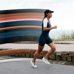 A runner with colored pixel streaks behind her