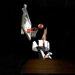 A basketball player dunking through 3D text