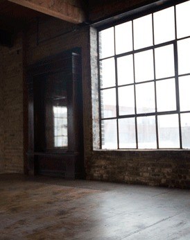 Empty industrial room with tall arched windows
