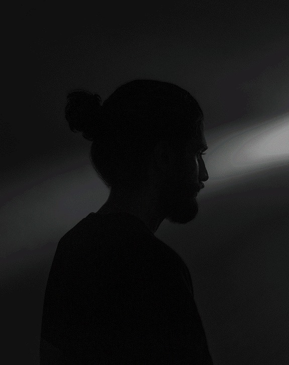 Silhouette of a person against a dark background