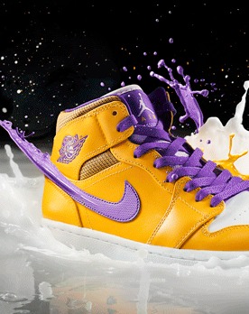 The same sneaker erupting in a splash of white liquid