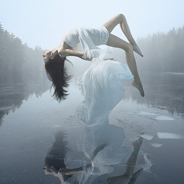 Woman in a white dress floating above a misty frozen lake with her reflection on the ice, course thumbnail for The Ultimate Guide to Manual Compositing in Photoshop