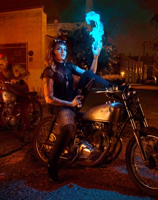 The same street with a rider on a motorcycle lit in cold blue