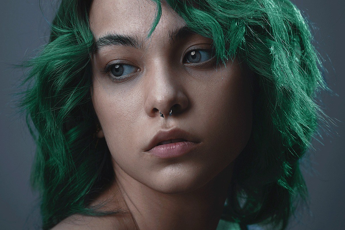Portrait of a woman with her hair recoloured bright green