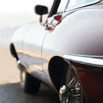 Close-up of a vintage silver convertible's front fender and side mirror with the background removed, example for removing anything in Photoshop