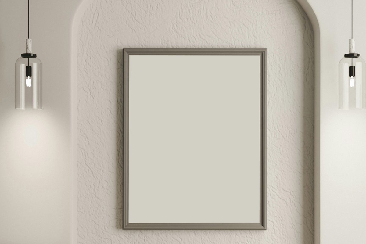 An empty picture frame on a white arched wall before placing the painting