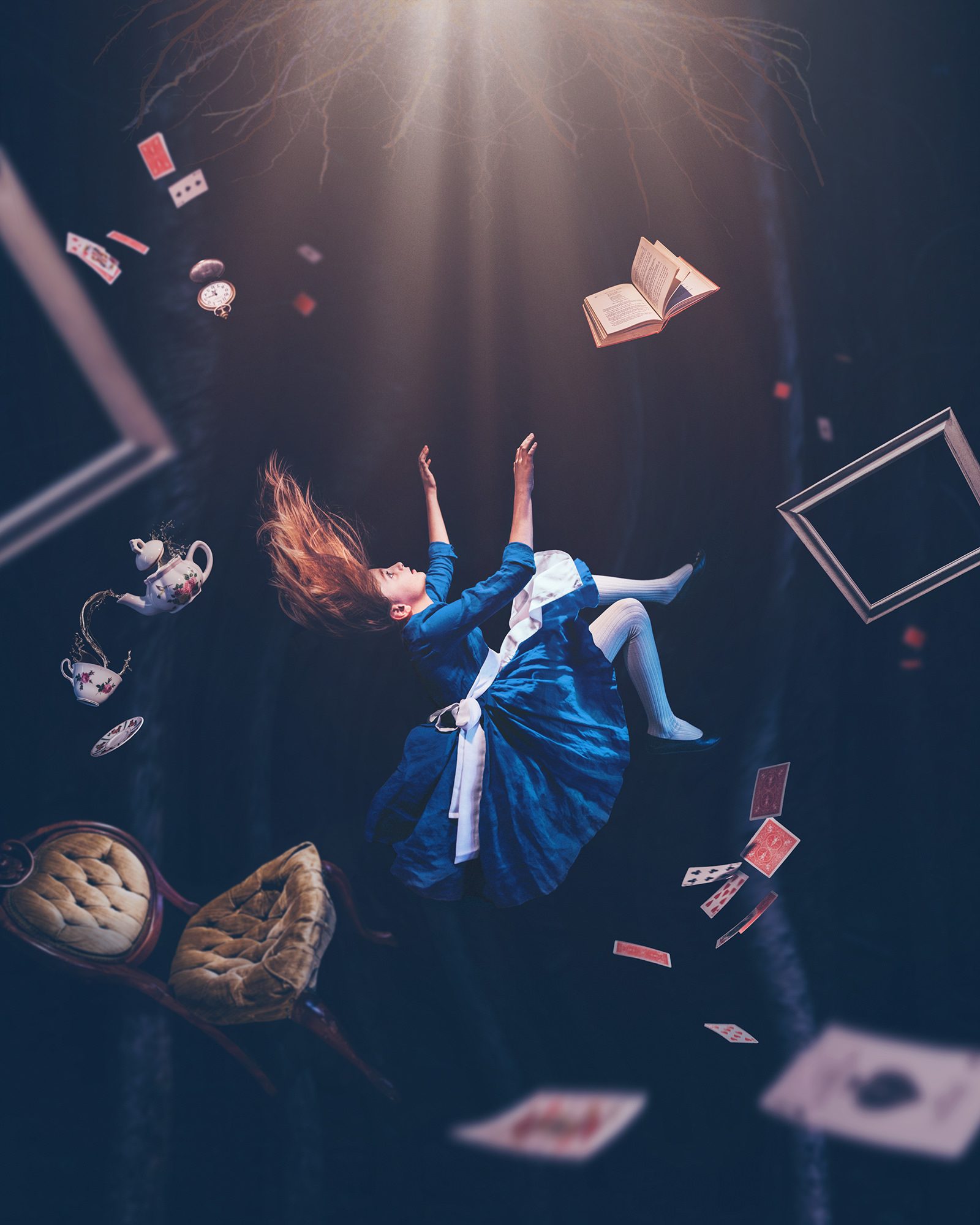 Composite of a girl in a blue Alice in Wonderland dress falling down a dark tunnel among cards, teacups and a chair