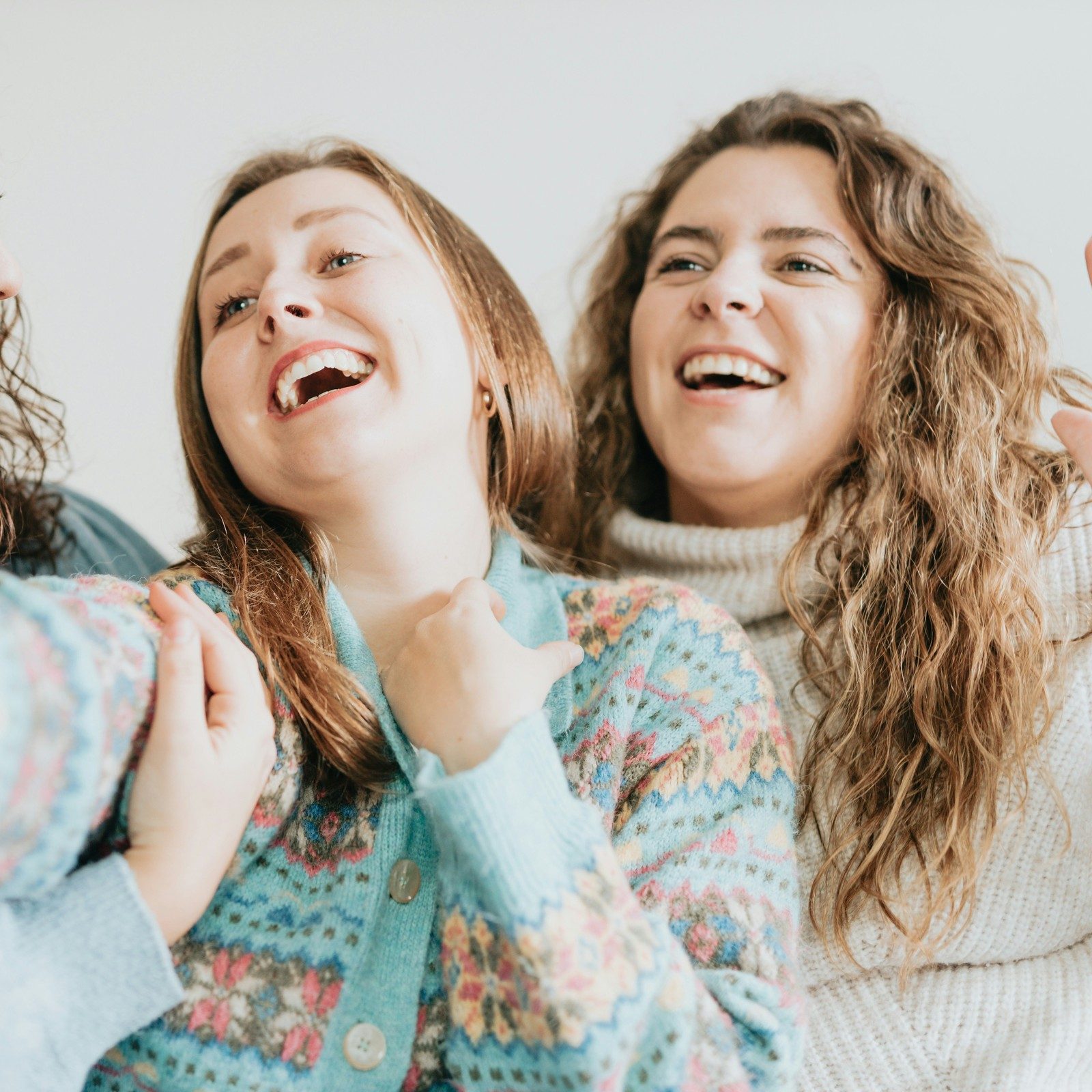 The same couch photo after Lightroom Open Eyes: the woman on the right now has her eyes open