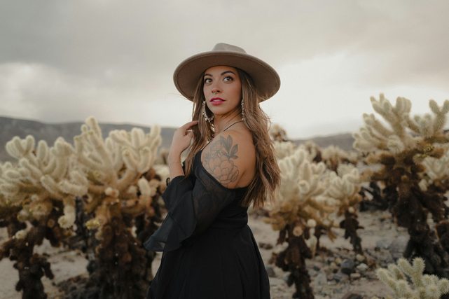 Woman in a wide-brim hat among cholla cactus