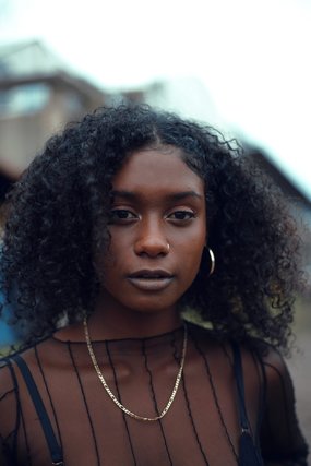 Woman with curly hair and hoop earrings