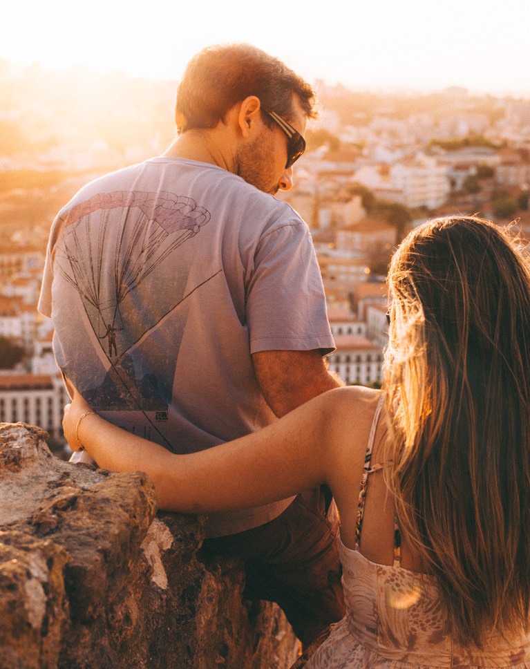 Light Rays Photoshop action after: couple on an overlook above a city with soft light rays