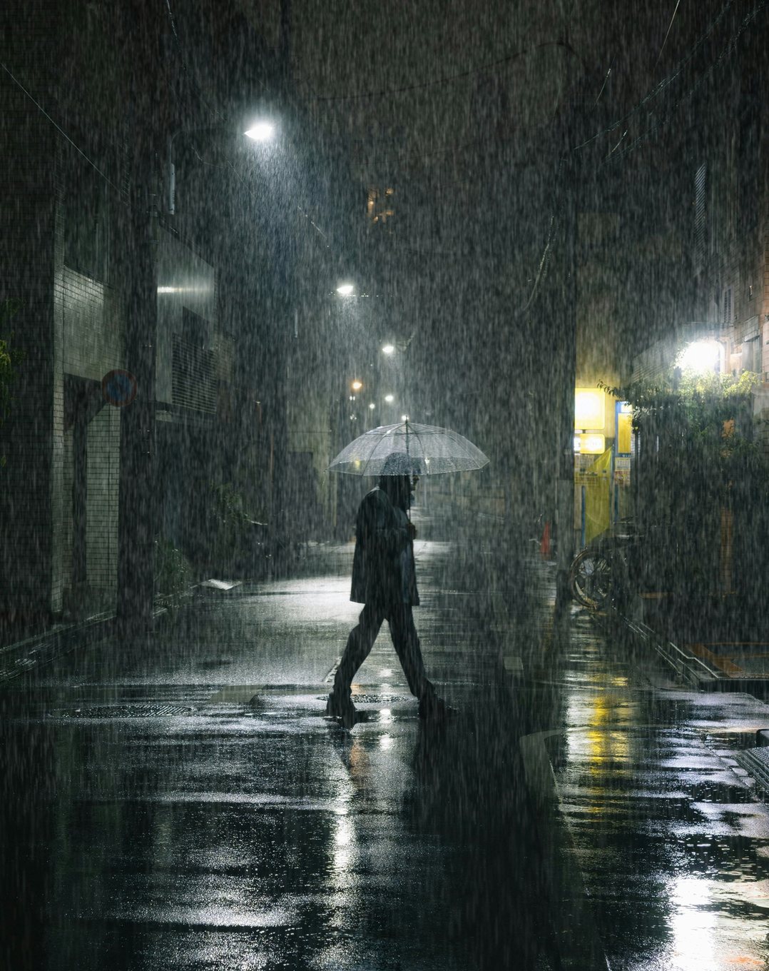 After: heavy rain painted down the lit alley, brightest under the lights, with the Rain Brushes